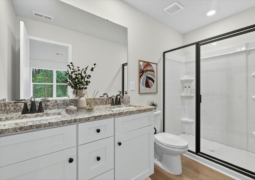 The master bathroom has a glass-enclosed shower The master bathroom has a glass-enclosed shower