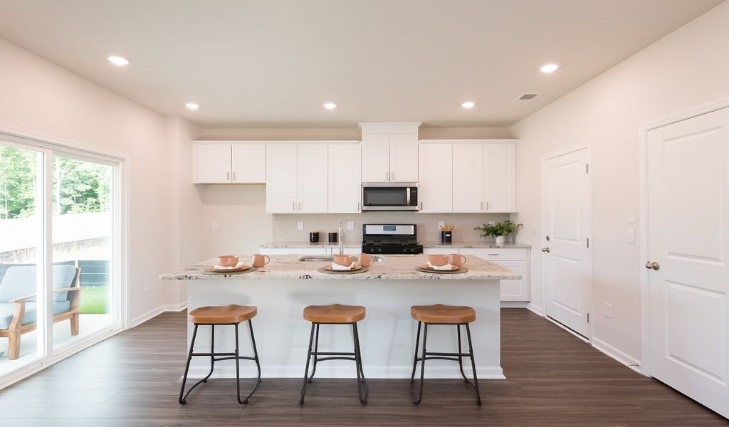 The spacious kitchen island overlooks the great room and covered patio.