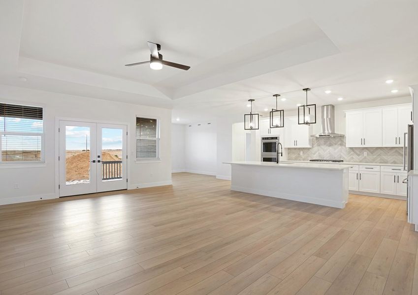 The kitchen, dining room and living room sit adjacent to one another.