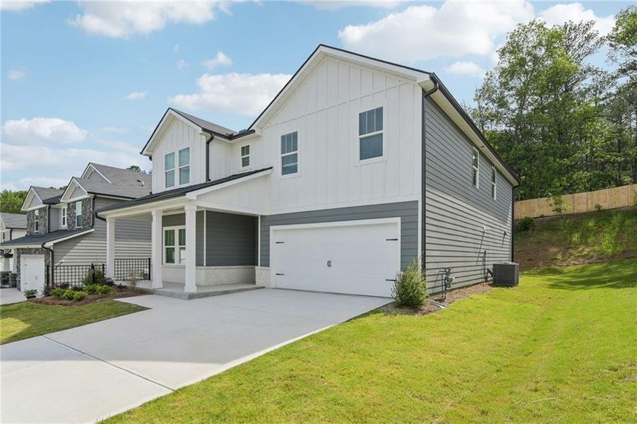 Front exterior of a new home in Ivey Township, Dallas, GA, highlighting curb appeal (Image 2).