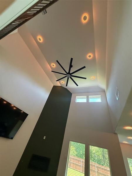 Soaring vaulted ceiling with recessed lighting and a multi-blade ceiling fan