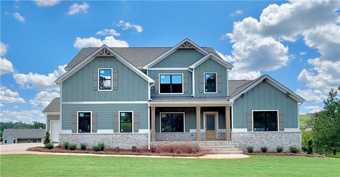 Front exterior of a new home in SteepleChase, Hoschton, GA, highlighting curb appeal (Image 2).
