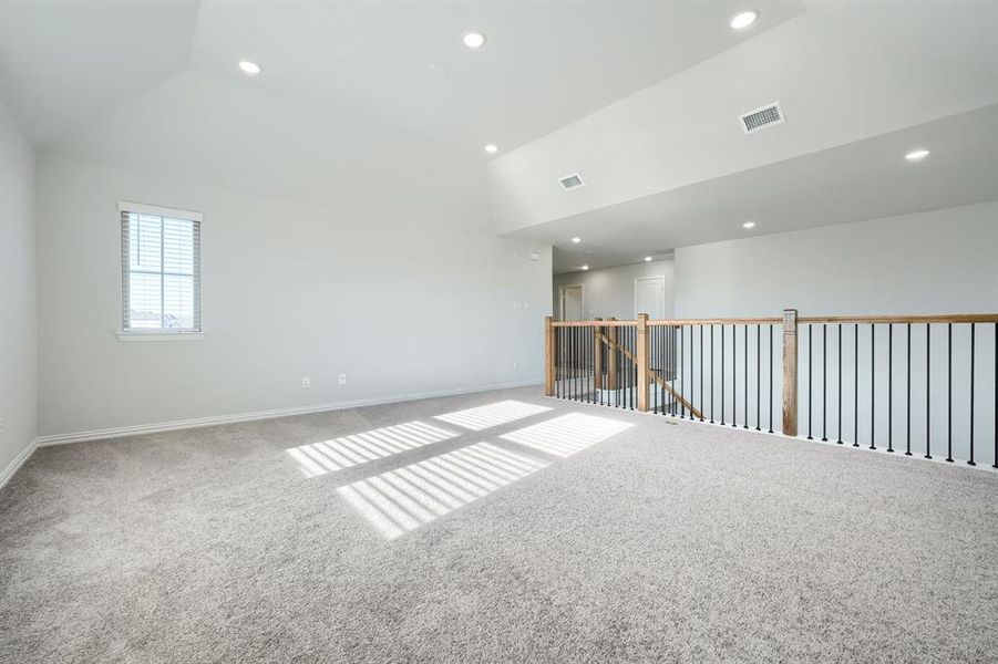 Unfurnished room with carpet floors, recessed lighting, and high vaulted ceiling Unfurnished room with carpet floors, recessed lighting, and high vaulted ceiling