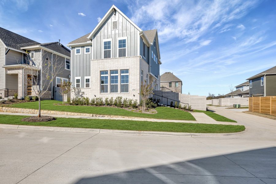 Front exterior of a new home in Painted Tree Woodland West – Village, McKinney, TX, highlighting curb appeal (Image 1). Front exterior of a new home in Painted Tree Woodland West – Village, McKinney, TX, highlighting curb appeal (Image 1).