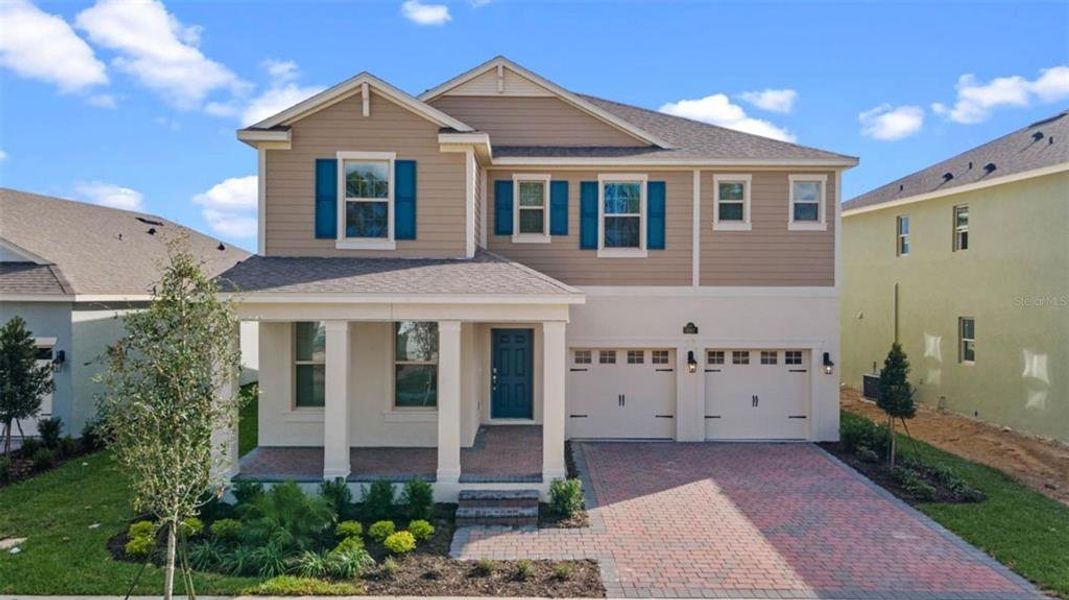 Front exterior of a new home in Waterleigh, Winter Garden, FL, highlighting curb appeal (Image 24).