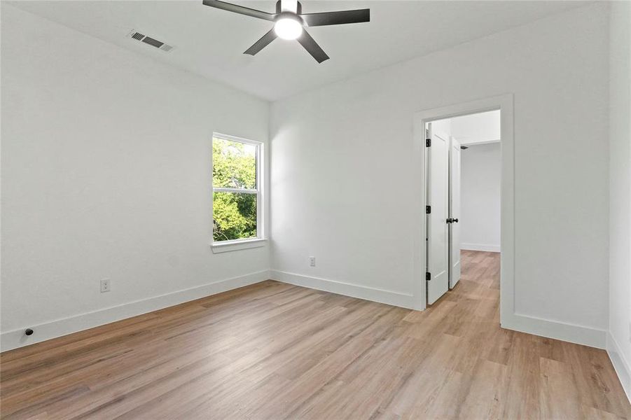 Unfurnished room with light wood-style flooring and ceiling fan