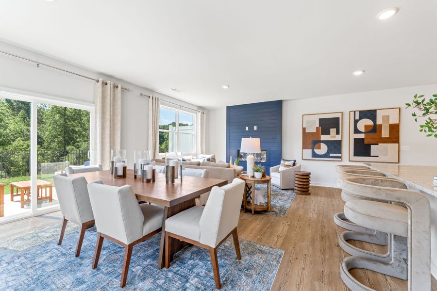 A large dining room with a large table and chairs. A large dining room with a large table and chairs.