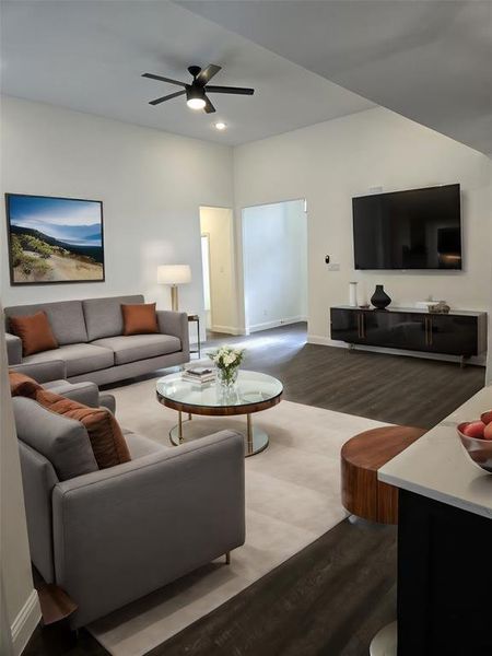 Living room with ceiling fan and wood-type flooring