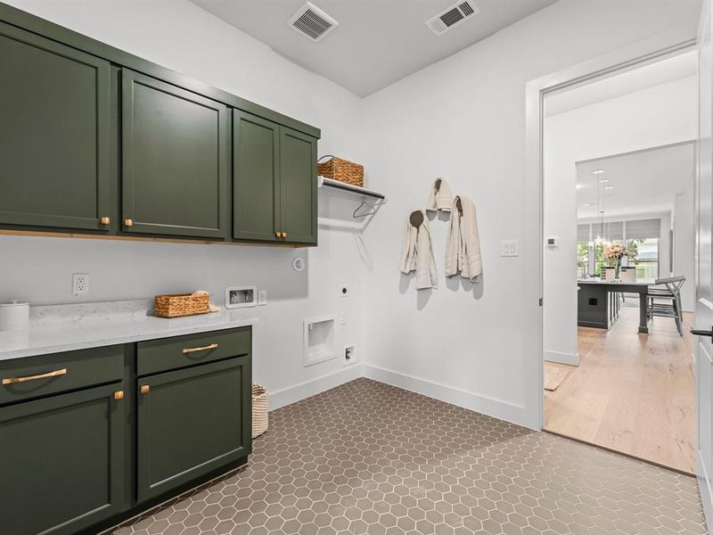 Utility Room with Washer and Dryer Connections, Storage Cabinets, Folding Area, and Hanging Bar