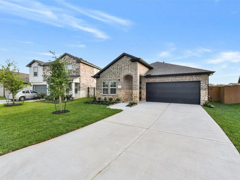 Front exterior of a new home in Sunterra, Katy, TX, highlighting curb appeal (Image 22).