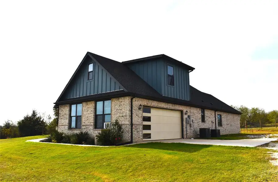Front exterior of a new home in , Grandview, TX, highlighting curb appeal (Image 2). Front exterior of a new home in , Grandview, TX, highlighting curb appeal (Image 2).