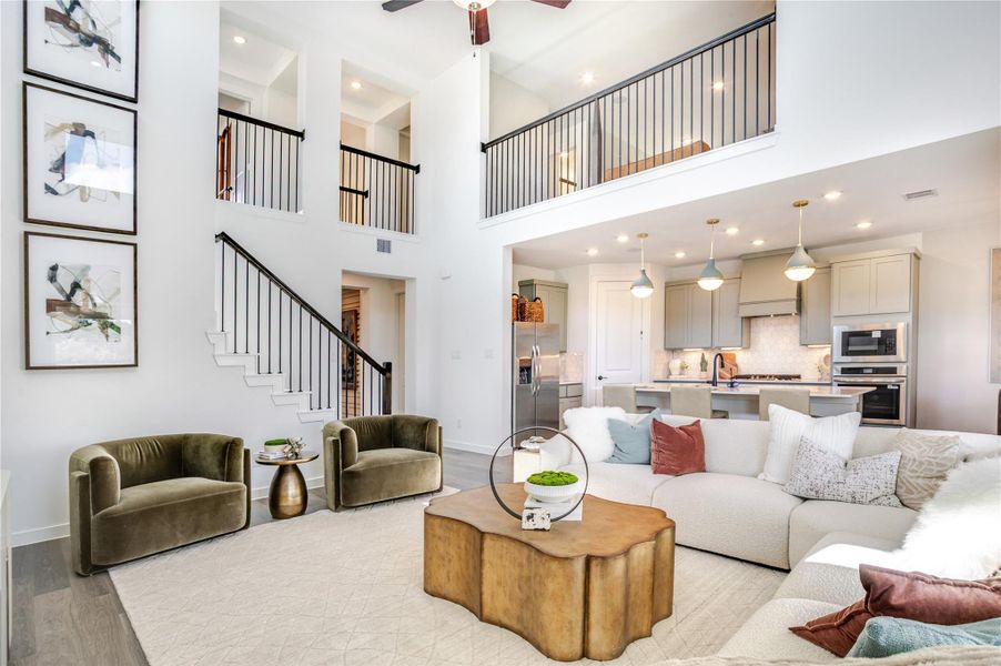 Notice the modern living area featuring high ceilings and an open floor plan connecting to the modern kitchen and sleek cabinetry with large island. Notice the modern living area featuring high ceilings and an open floor plan connecting to the modern kitchen and sleek cabinetry with large island.