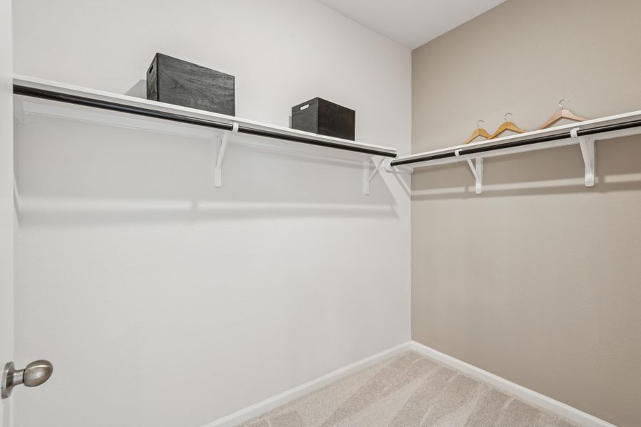 Primary Walk-In Closet. Staged model home shown for illustration only; actual features, colors, and upgrades may vary. Primary Walk-In Closet. Staged model home shown for illustration only; actual features, colors, and upgrades may vary.