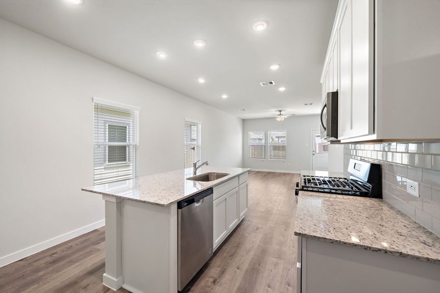 A kitchen with white cabinets.