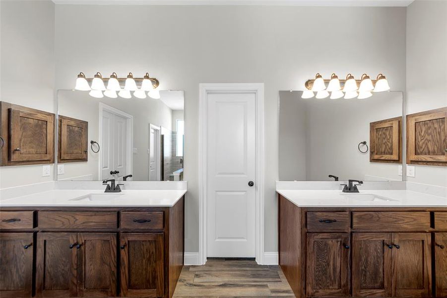 Bathroom with two vanities and wood finished floors Bathroom with two vanities and wood finished floors