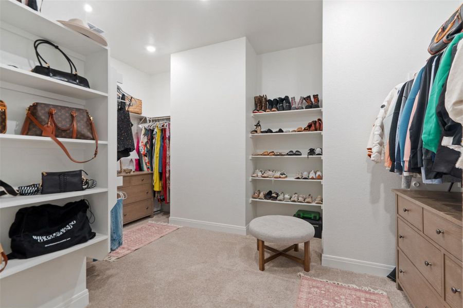A well-organized dressing area with built-in shelving and ample storage options. A well-organized dressing area with built-in shelving and ample storage options.