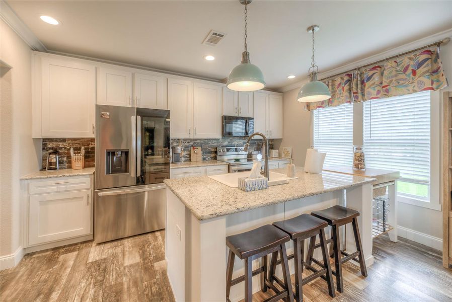 Large kitchen with granite countertops.