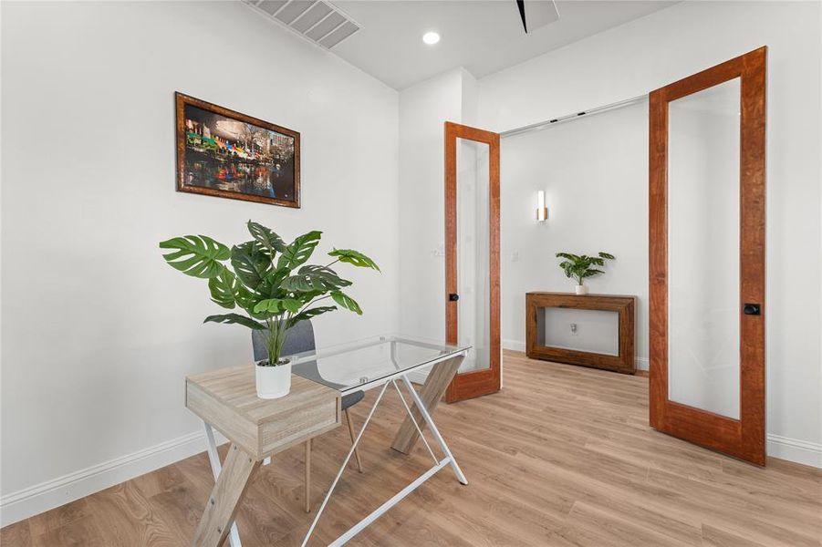 Office area featuring light wood-type flooring and recessed lighting