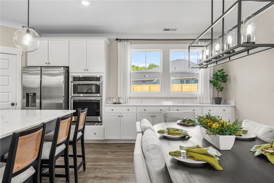 An inviting eat-in kitchen with elegant finishes p