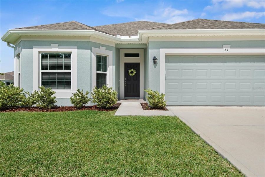 Front exterior of a new home in Sawmill Creek at Palm Coast Park, Palm Coast, FL, highlighting curb appeal (Image 2). Front exterior of a new home in Sawmill Creek at Palm Coast Park, Palm Coast, FL, highlighting curb appeal (Image 2).