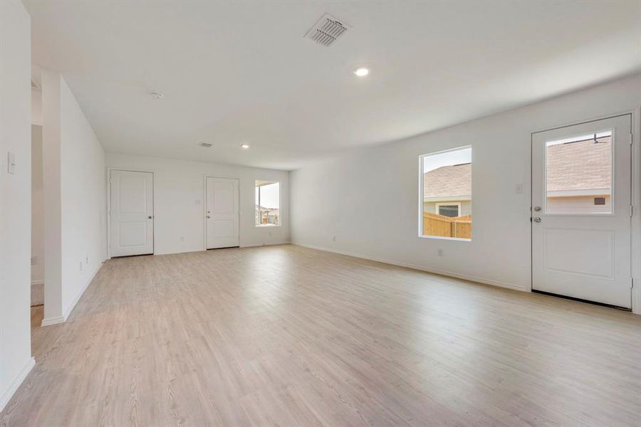 Spare room with light hardwood / wood-style flooring and a healthy amount of sunlight