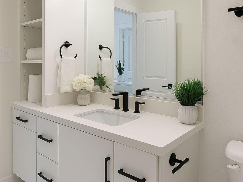 Stylish secondary bathroom featuring modern fixtures, sleek vanity, and a tub/shower combo with elegant tile surround.
