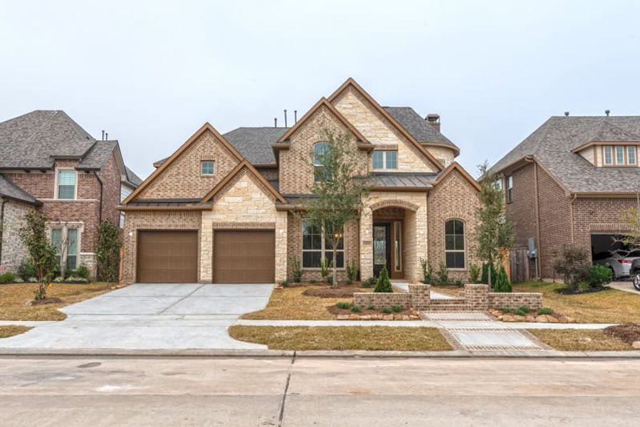 Representative exterior photo of a completed home built from the 3799 by Ravenna Homes in The Woodlands Hills 65′, Willis, TX (Image 2). Representative exterior photo of a completed home built from the 3799 by Ravenna Homes in The Woodlands Hills 65′, Willis, TX (Image 2).