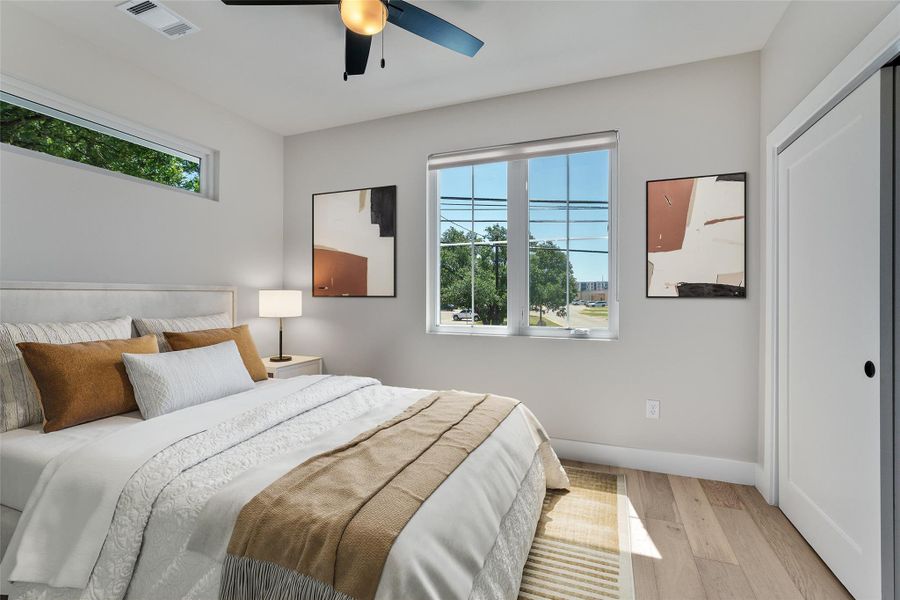 Virtually Staged. Spacious secondary bedroom with full bathroom. Featuring wood flooring, a contemporary ceiling fan, and multiple windows. Virtually Staged. Spacious secondary bedroom with full bathroom. Featuring wood flooring, a contemporary ceiling fan, and multiple windows.