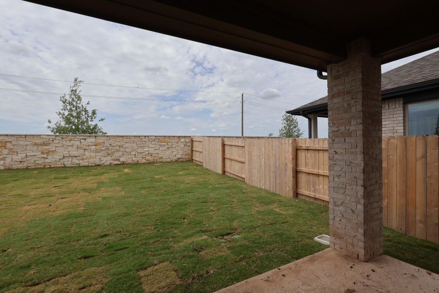 Front exterior of a new home in Flora, Hutto, TX, highlighting curb appeal (Image 22).