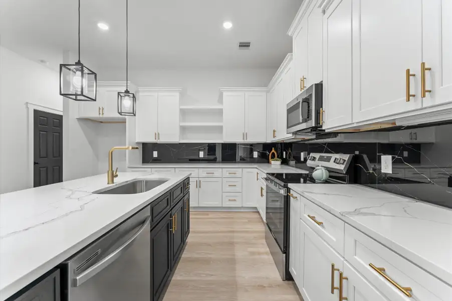 Stainless steel appliances and stylish backsplash complete the look. Stainless steel appliances and stylish backsplash complete the look.