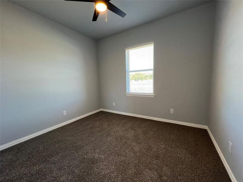 Empty room with carpet flooring and ceiling fan