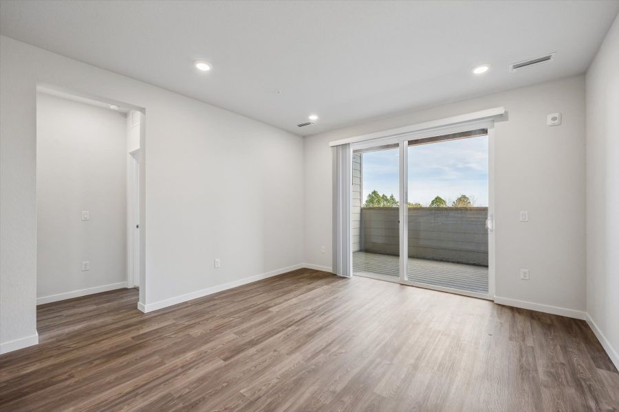 A room with a wood floor and white walls.