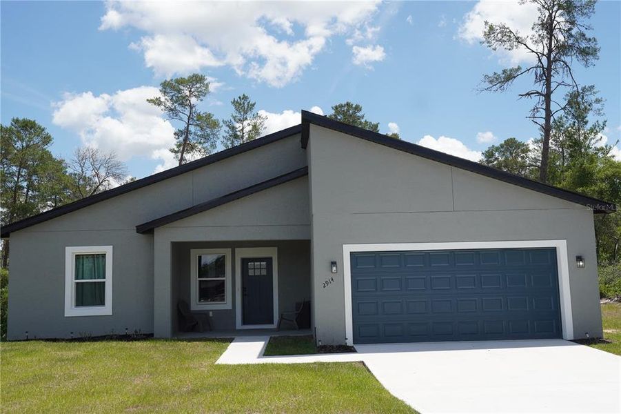 Front exterior of a new home in , Ocala, FL, highlighting curb appeal (Image 27).