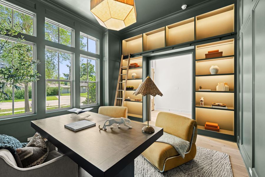 Elegant study features backlit shelves with rolling ladder and spacious walk-in closet with hidden door. Elegant study features backlit shelves with rolling ladder and spacious walk-in closet with hidden door.