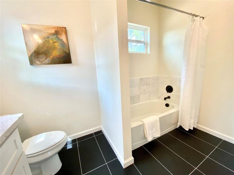 Bathroom with vanity, tile patterned floors, and toilet