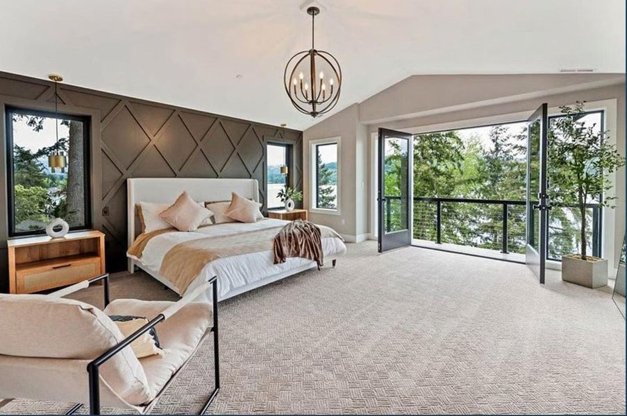 Bedroom with an accent wall, carpet floors, a chandelier, and access to outside