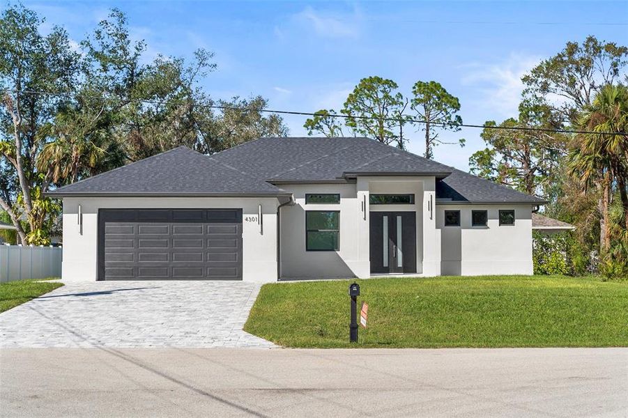 Front exterior of a new home in , North Port, FL, highlighting curb appeal (Image 1).