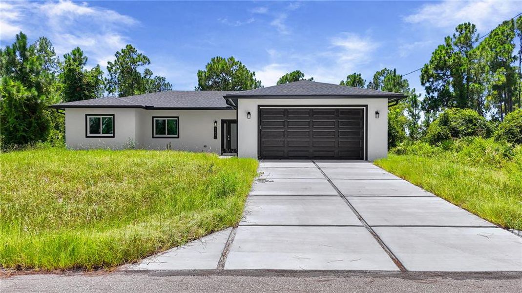 Front exterior of a new home in , Lehigh Acres, FL, highlighting curb appeal (Image 22). Front exterior of a new home in , Lehigh Acres, FL, highlighting curb appeal (Image 22).