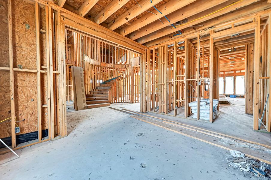 Open unfinished space showcasing framing and build progress.