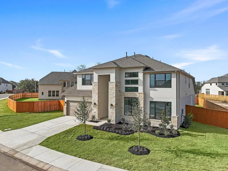 Front exterior of a new home in Parmer Ranch, Georgetown, TX, highlighting curb appeal (Image 22).