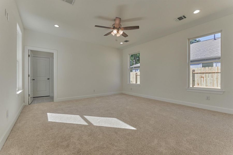 Secluded owner's retreat has superb natural lighting, plush carpeting, and a ceiling fan. Secluded owner's retreat has superb natural lighting, plush carpeting, and a ceiling fan.
