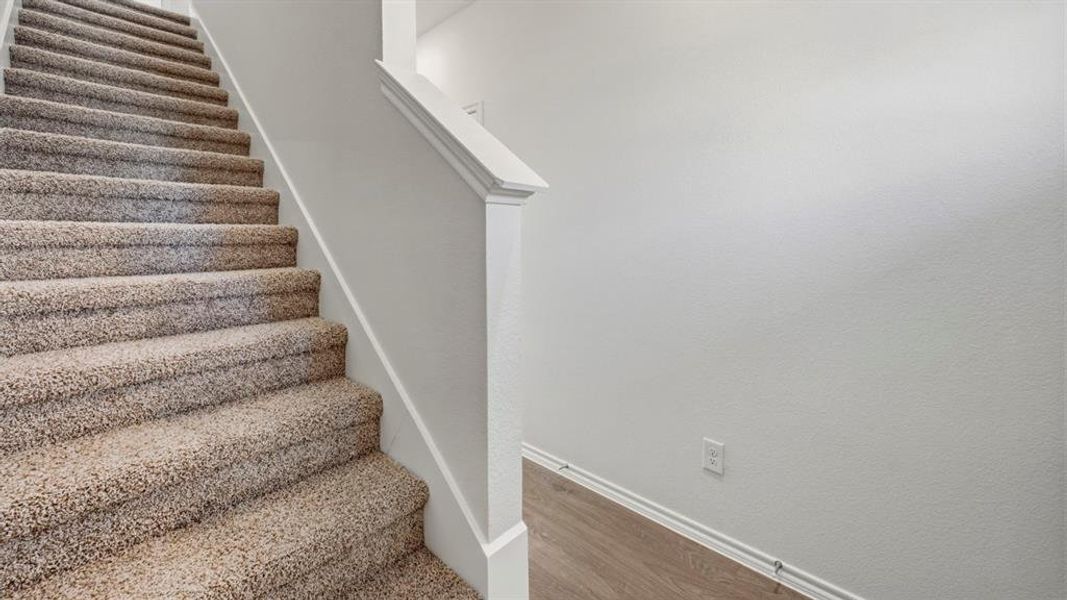 Stairs with baseboards and wood finished floors