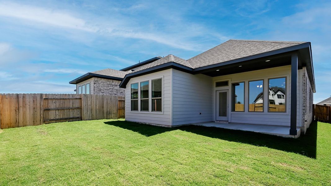 Back of house featuring a fenced backyard, a patio, and a shingled roof Back of house featuring a fenced backyard, a patio, and a shingled roof