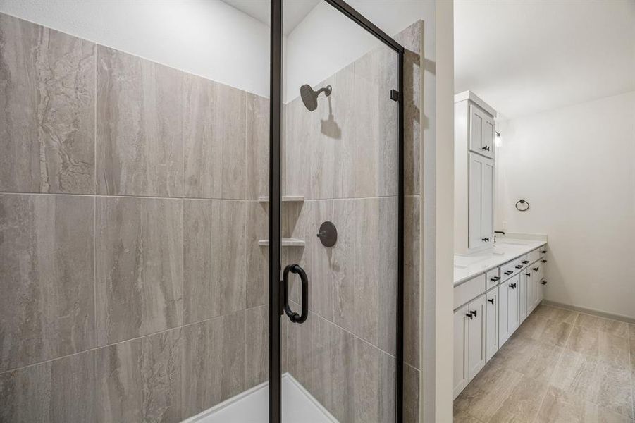 In addition to ample vanity and storage space, you'll enjoy a spacious walk in shower in this dream owner's bath!