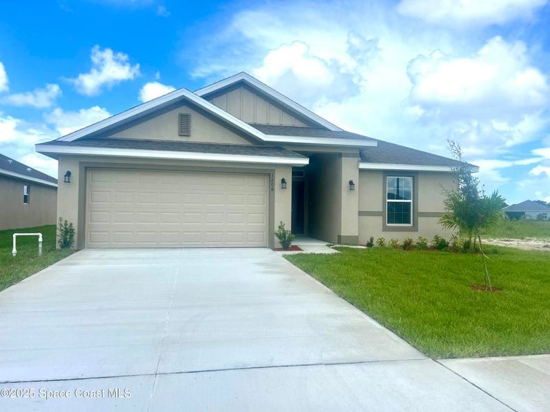 Front exterior of a new home in St. John Preserve, Palm Bay, FL, highlighting curb appeal (Image 1).