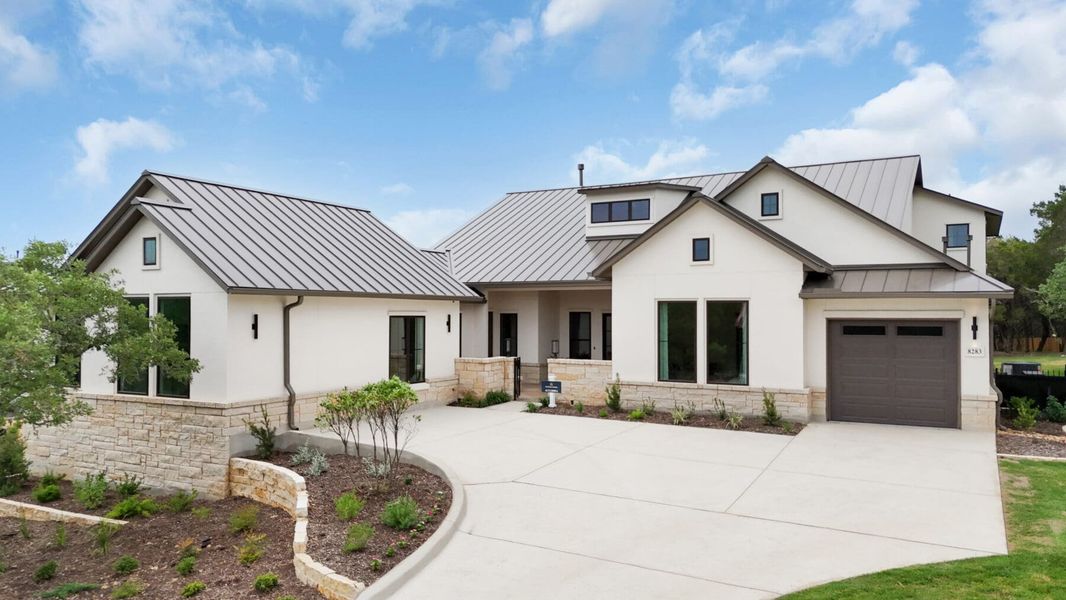Front exterior of a new home in Enchanted Bluff, Garden Ridge, TX, highlighting curb appeal (Image 2).
