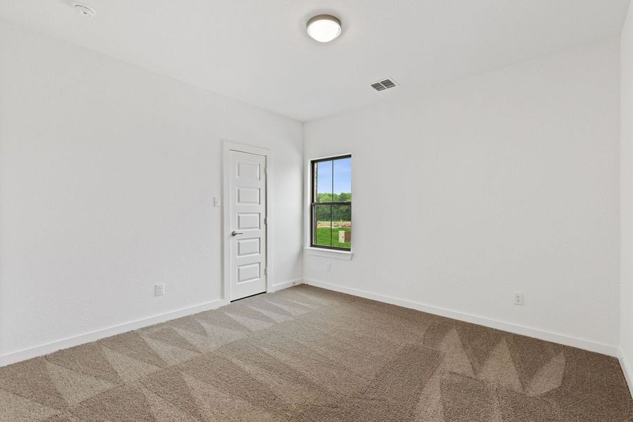 Bedroom in the Stanley II home plan by Trophy Signature Homes – REPRESENTATIVE PHOTO