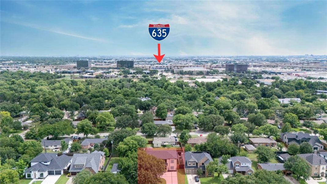 Aerial perspective showcasing the residential neighborhood with a prominent red-roofed property
