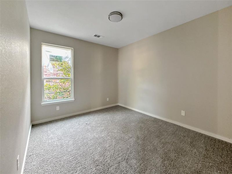 Spare room featuring carpet and baseboards