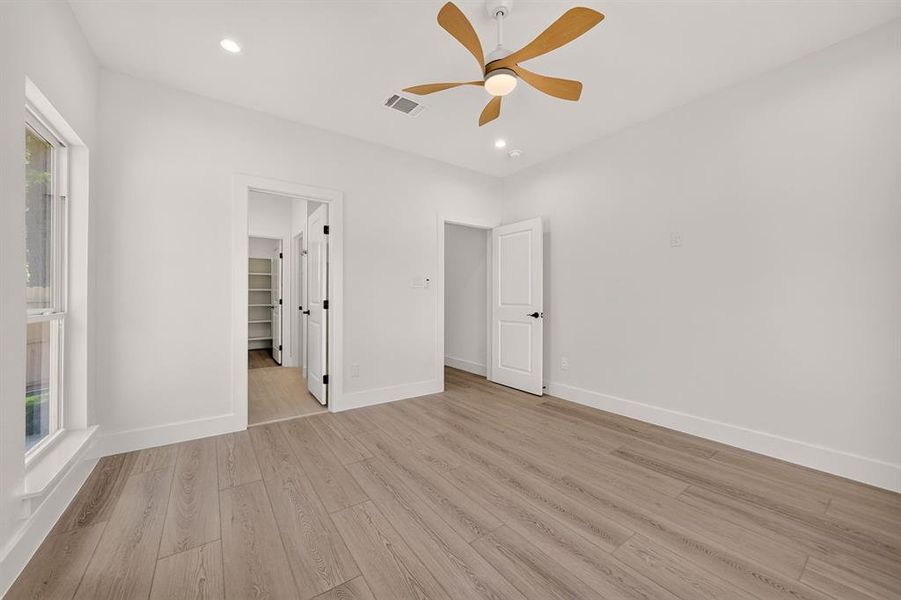 Bright interior space featuring wood-finish flooring, recessed lighting, and a ceiling fan